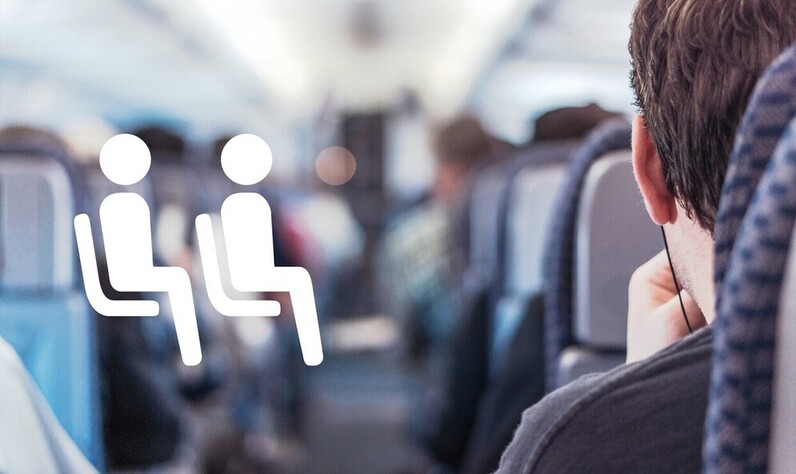 Picture of passengers in the aisle of an airplane