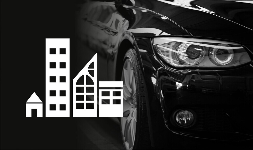 Attēls ar automašīnu tuvplānā, balta piktogramma ar pilsētas siluetu